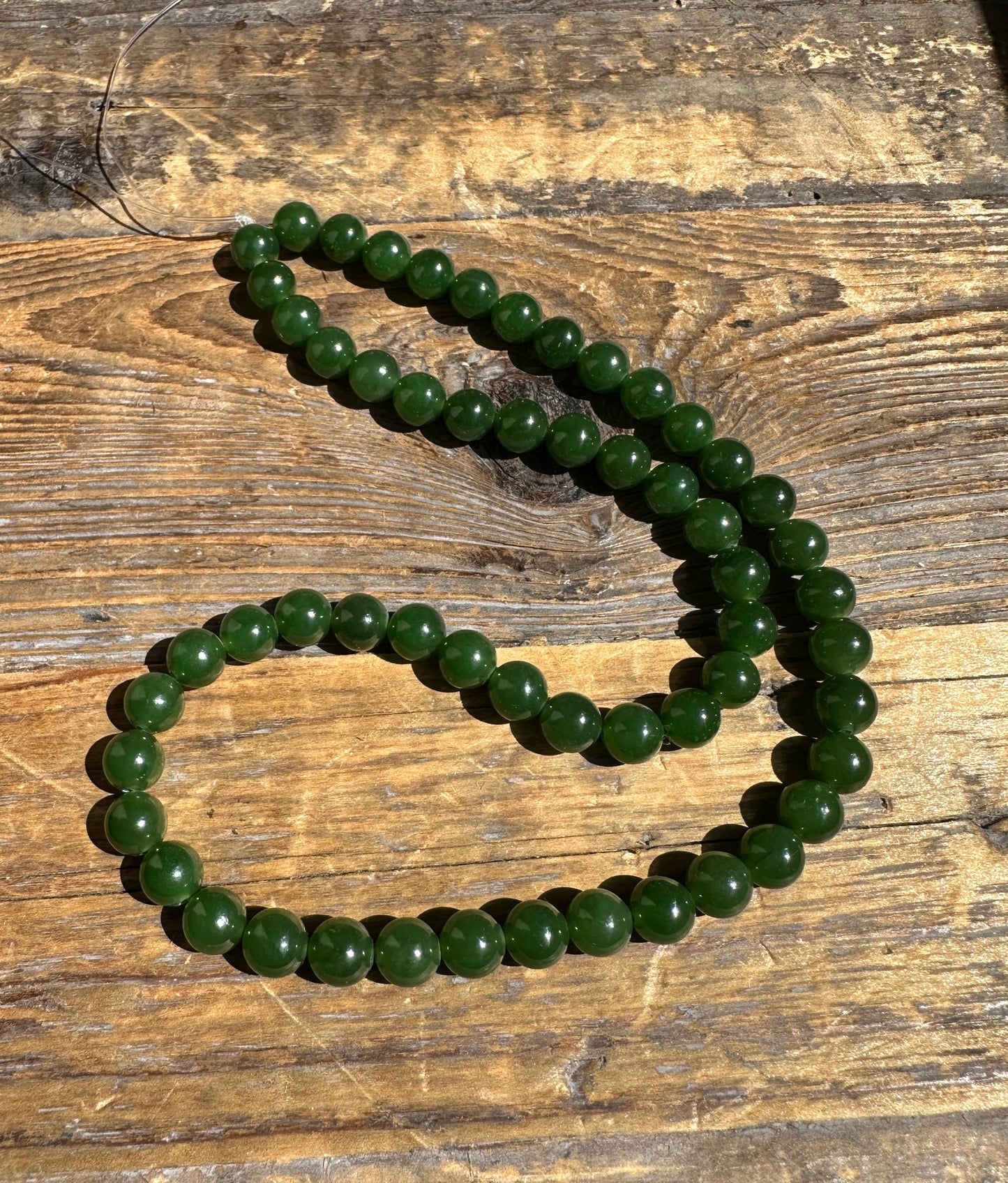 A Grade 7mm Nephrite Jade Beads, unstrung 16"