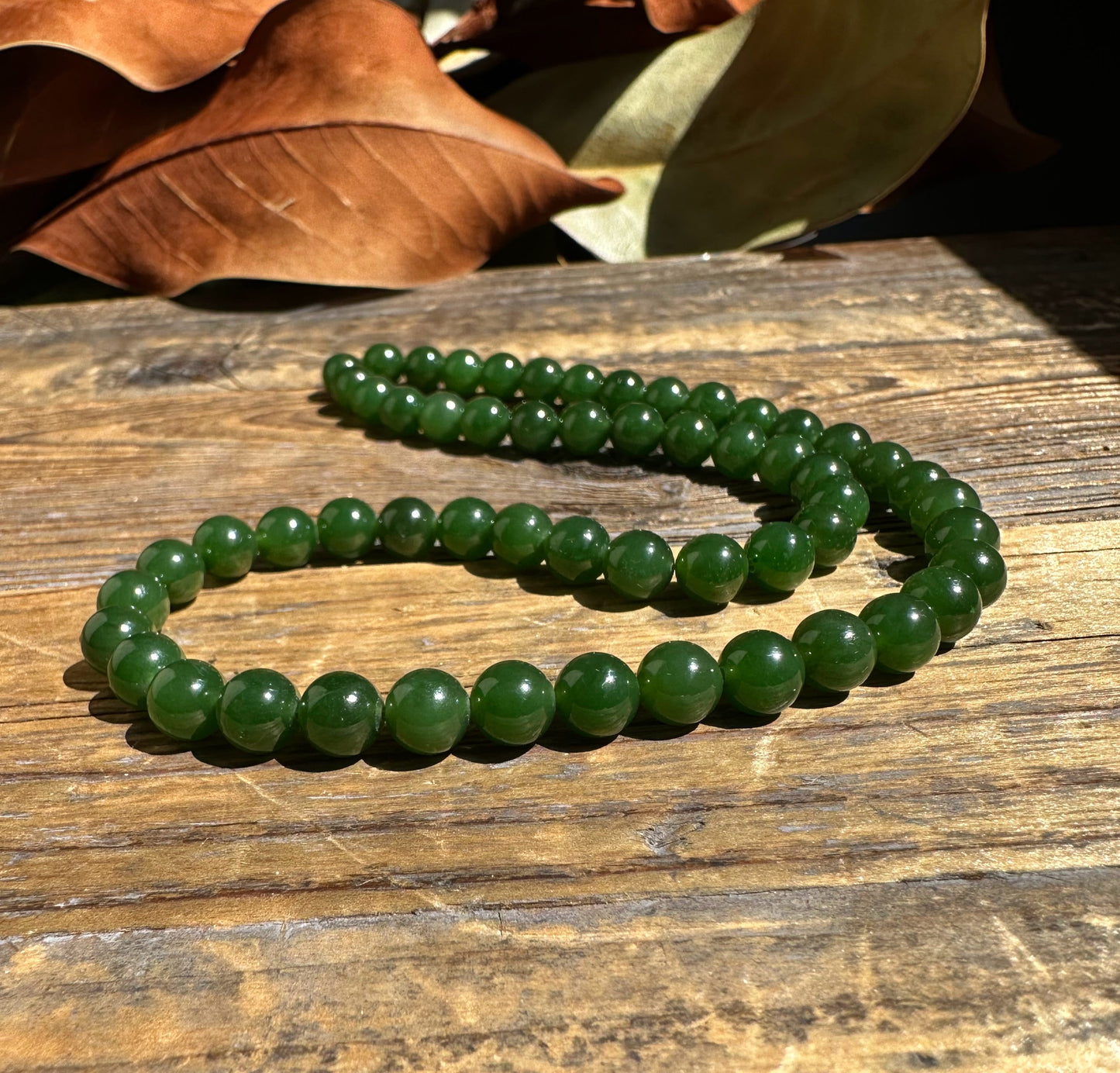 A Grade 7mm Nephrite Jade Beads, unstrung 16"