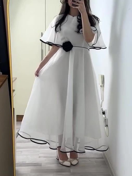 White Chiffon Maxi Dress With Black Trim And Floral Accent
