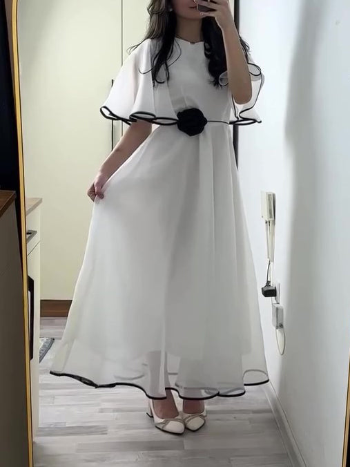 White Chiffon Maxi Dress With Black Trim And Floral Accent