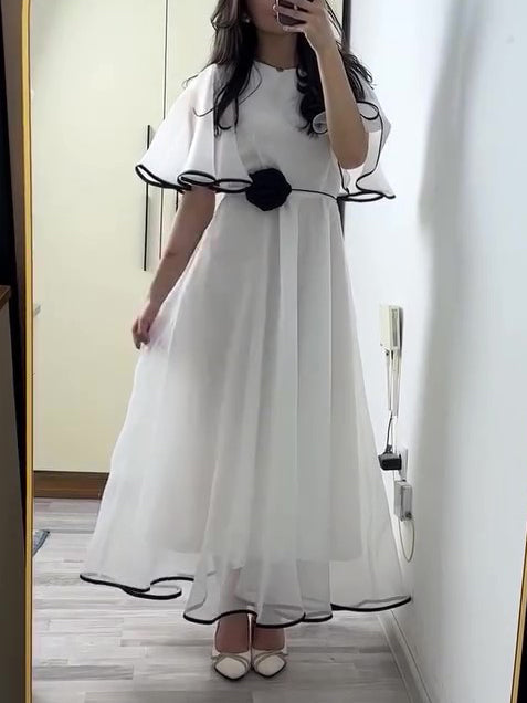 White Chiffon Maxi Dress With Black Trim And Floral Accent